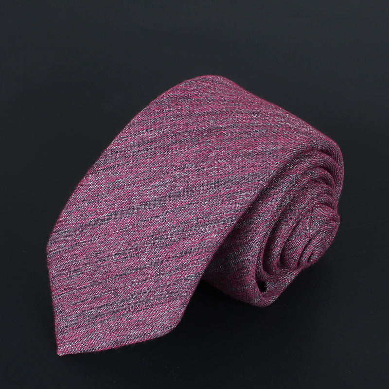 Pink and gray patterned tie on a black background