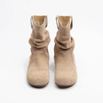 Pair of beige ankle boots on a white background