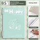 Notebook with 'BE HAPPY' text and illustrations on a green background