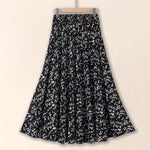 Black floral patterned skirt on a beige background