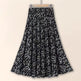 Black floral patterned skirt on a beige background