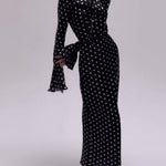 Black dress with white polka dots on a white background