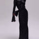 Black dress with white polka dots on a white background