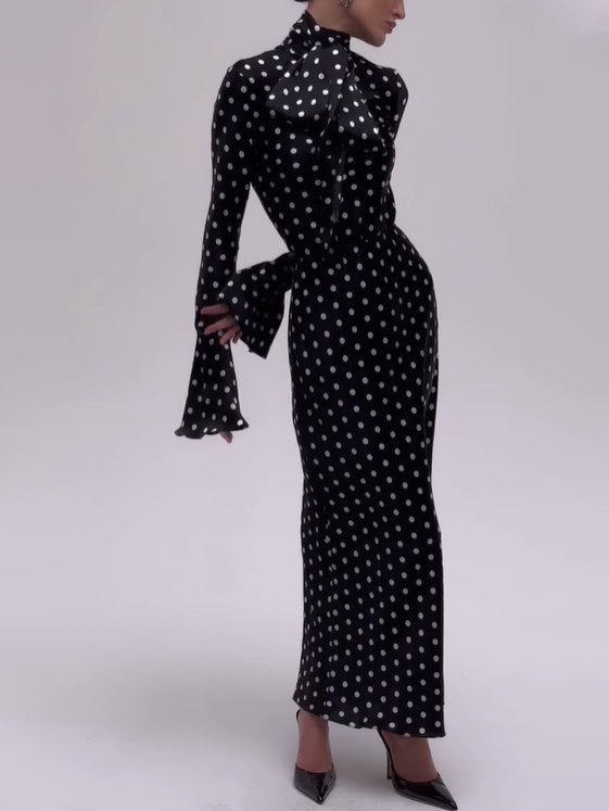 Black dress with white polka dots on a white background