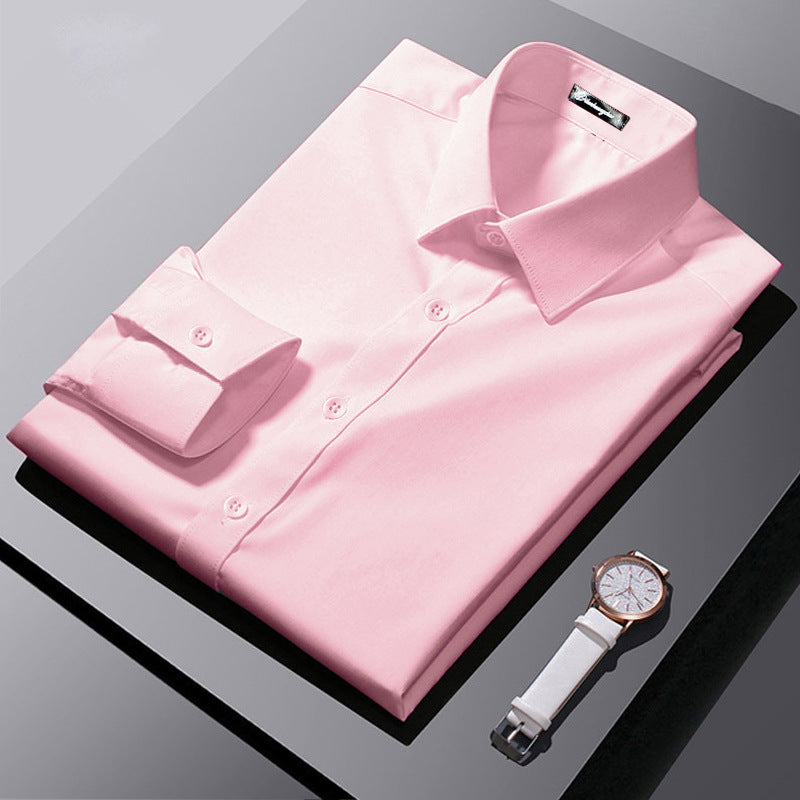 Folded pink dress shirt with a white watch on a reflective surface