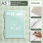 Notebook with a whale illustration on a green checkered background