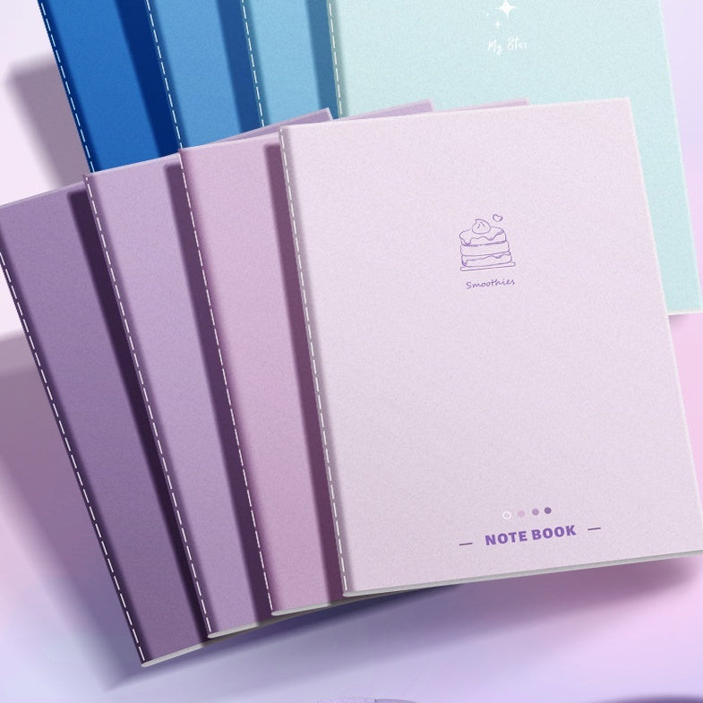 Set of pastel-colored notebooks with a visible brand logo on a light background