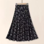 Black floral patterned skirt on a beige background