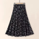 Black floral patterned skirt on a beige background