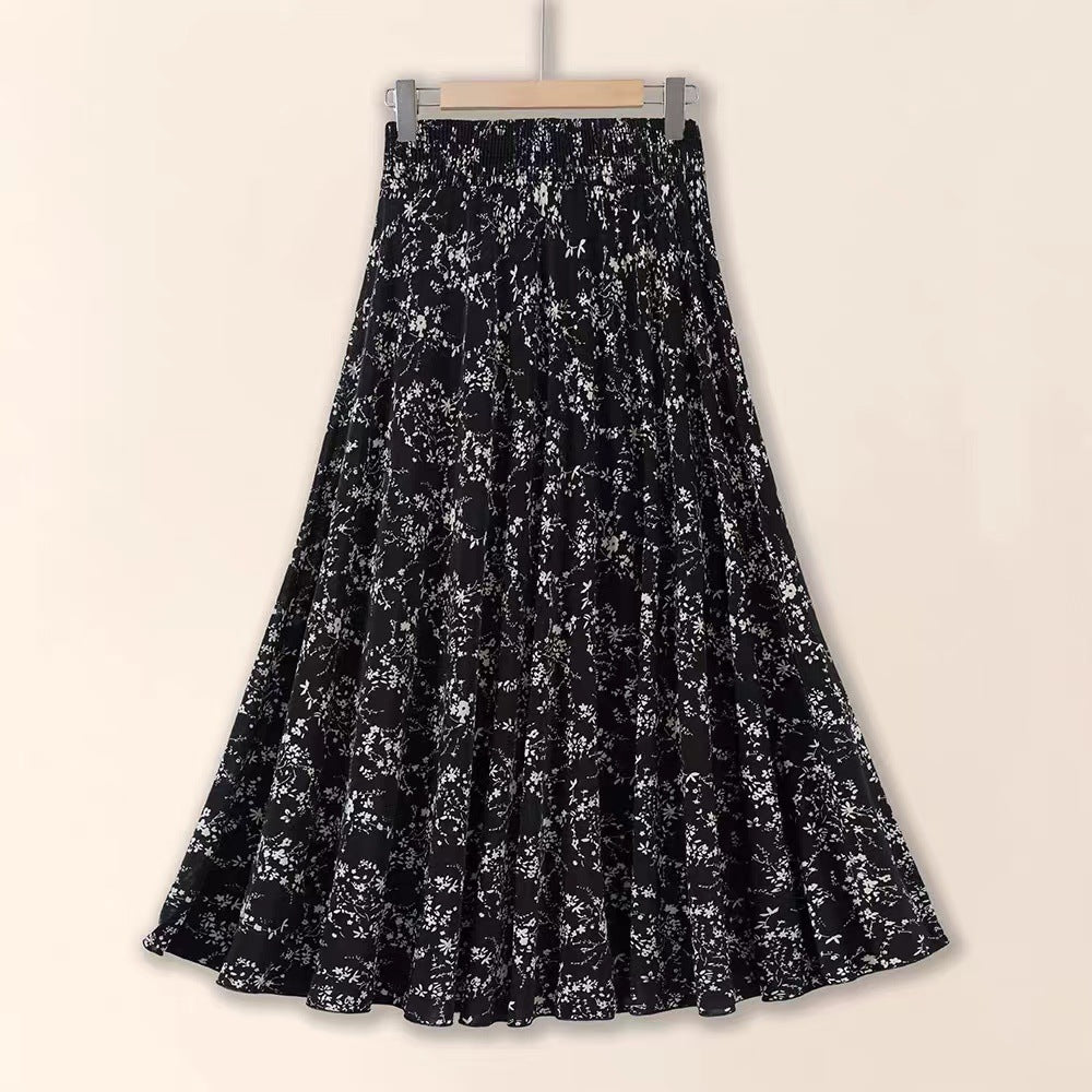 Black floral patterned skirt on a beige background