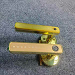 Gold door handle on a textured gray background