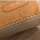 Close-up of a tan suede shoe with a tan leather patch embossed with the numbers '177 230' and a thick beige sole.