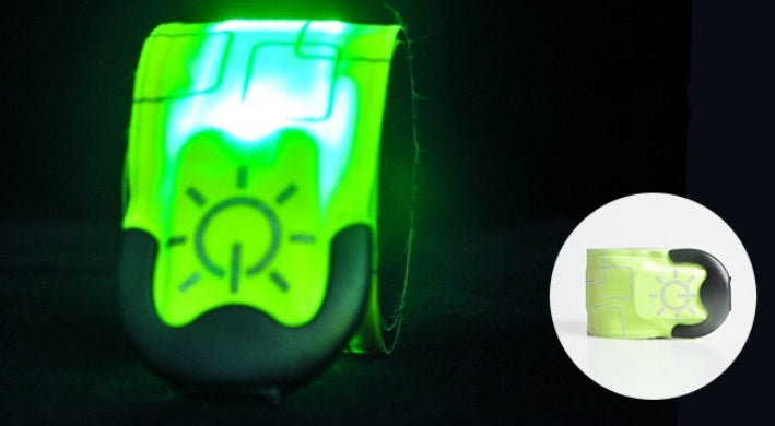 Green LED wristband glowing in the dark with inset showing product details.