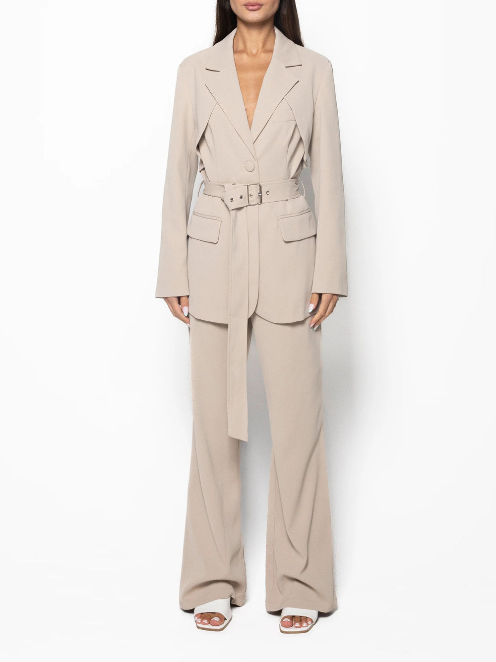 Beige suit with a belt worn by a model on a white background