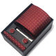 Maroon patterned tie, pocket square, and cufflinks set in a black box on a white background