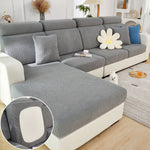 Gray sectional sofa with decorative pillows in a living room setting.