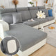 Gray sectional sofa with decorative pillows in a living room setting.