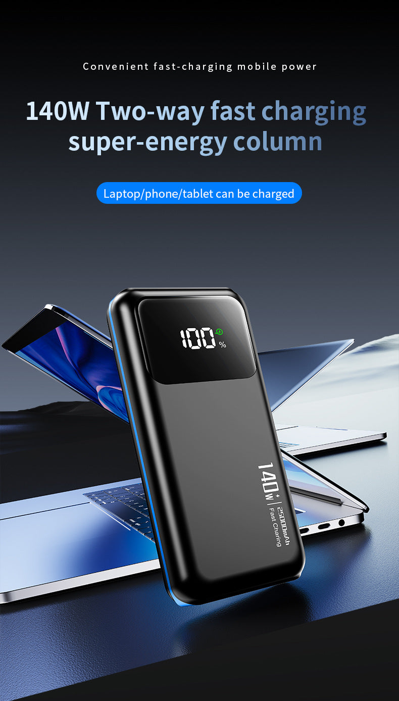 A black portable power bank with a digital display showing 100% battery level, standing upright in front of laptops and a tablet on a dark blue surface. Text at the top reads '140W Two-way fast charging super-energy column' and 'Laptop/phone/tablet can be charged'.