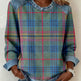 Person wearing a plaid shirt with denim sleeves against a neutral background