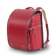 Red backpack on a white background