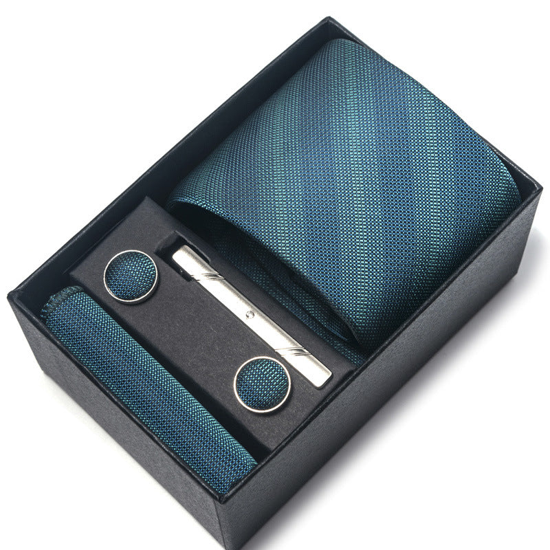 Teal tie set with matching pocket square, tie clip, and cufflinks in a black box on a white background.