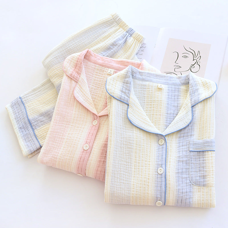 Three folded long-sleeve pajama shirts in pastel striped colors are arranged on a white background. The front shirt is cream, light blue, and lavender, with a light blue piping collar.