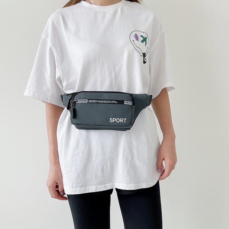 Person wearing a white t-shirt with a graphic design and a gray waist bag on a plain background
