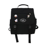 Black backpack with colorful patches on a white background