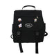 Black backpack with colorful patches on a white background