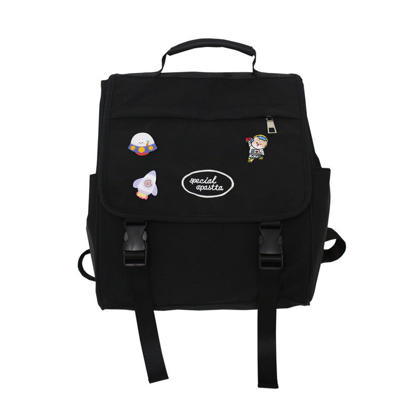 Black backpack with colorful patches on a white background