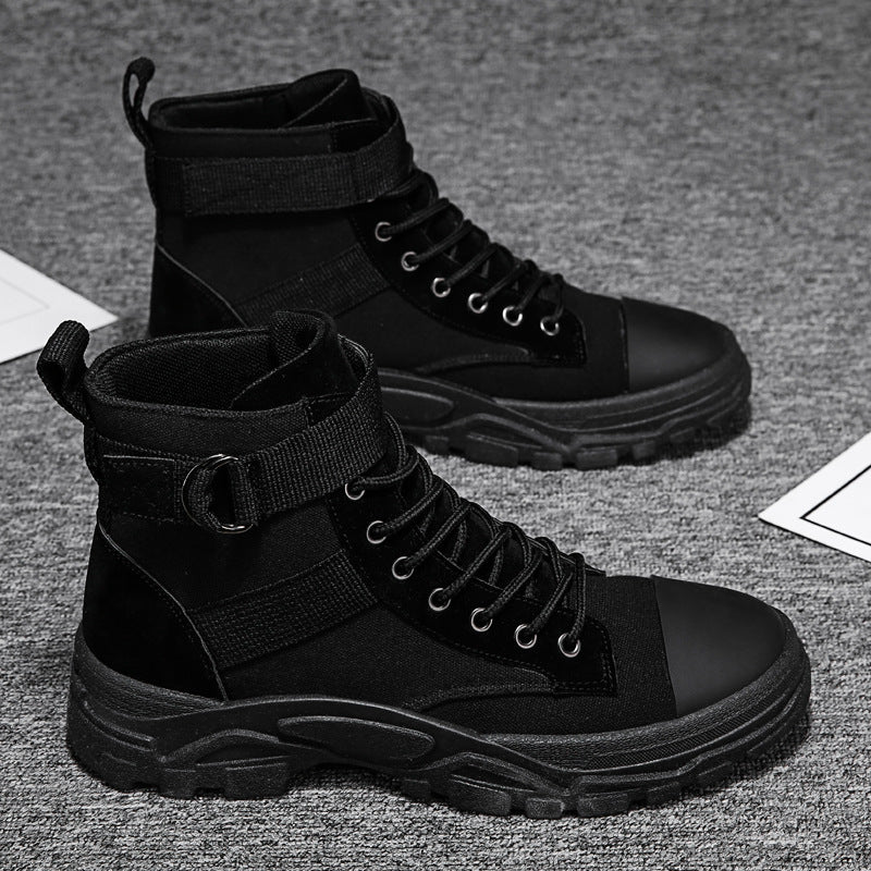 Black high-top boots on a textured gray surface
