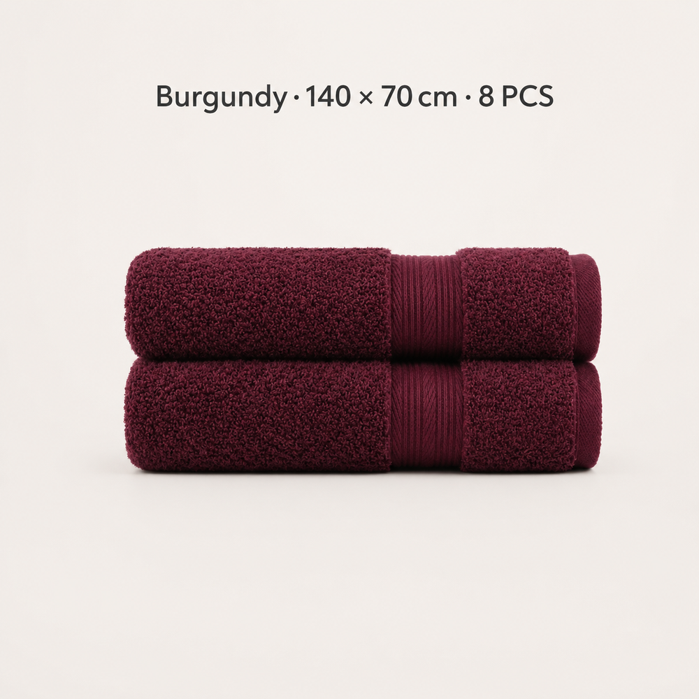 Two folded burgundy towels stacked horizontally on a light off-white background, with text above reading 'Burgundy × 140 × 70 cm · 8 PCS'.