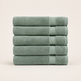 A stack of five folded bath towels in a muted sage green color, arranged vertically against a clean, light beige background.