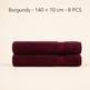 Two folded burgundy bath towels stacked horizontally on a light beige background, with text at the top reading 'Burgundy × 140 x 70 cm × 8 PCS'.