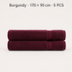 Two folded burgundy towels stacked on a light gray background, with text at the top reading 'Burgundy • 170 x 95 cm • 5 PCS'.