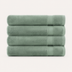 Four folded towels stacked vertically, made of soft textured fabric in a muted sage green color, set against a plain off-white background.
